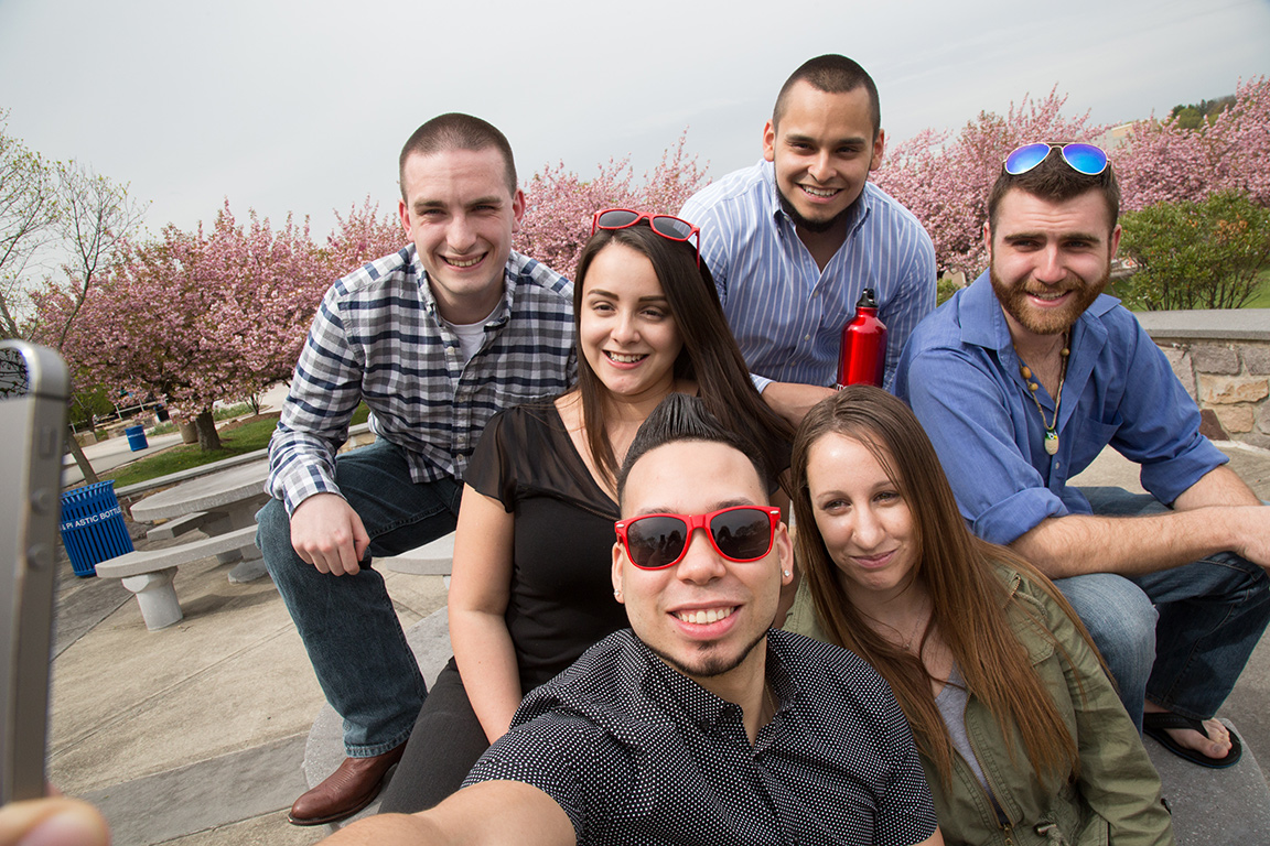 Students sitting outside at a table