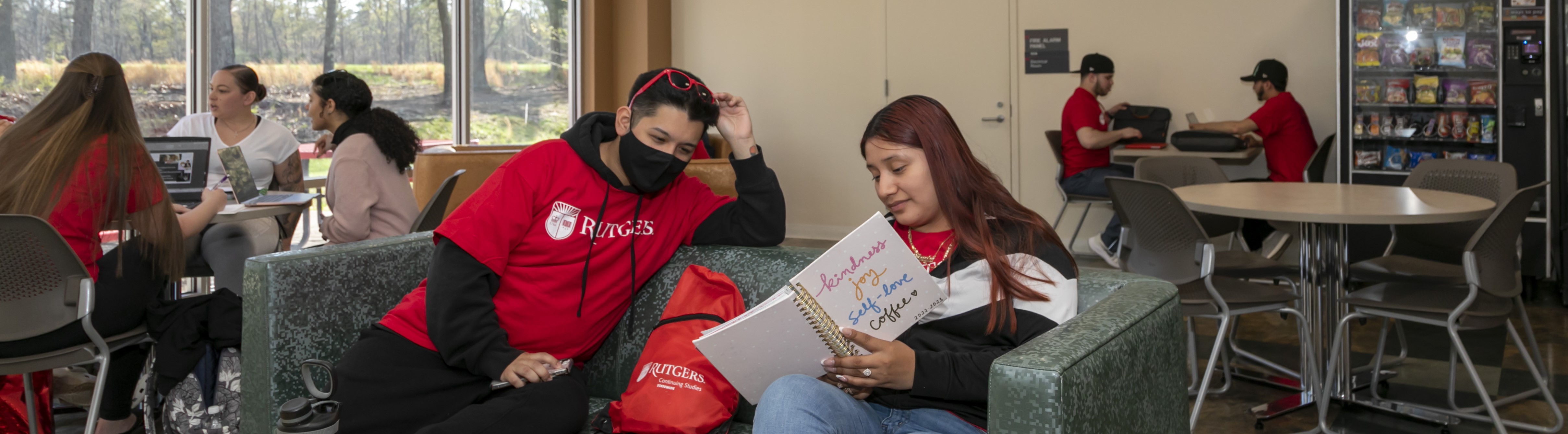 Students sitting on a couch studying