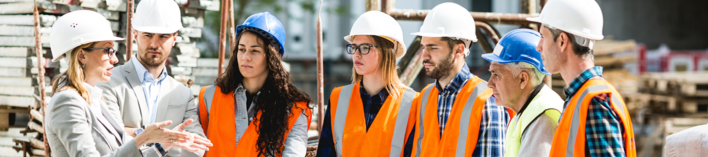 Group of people standing outside at a construction site