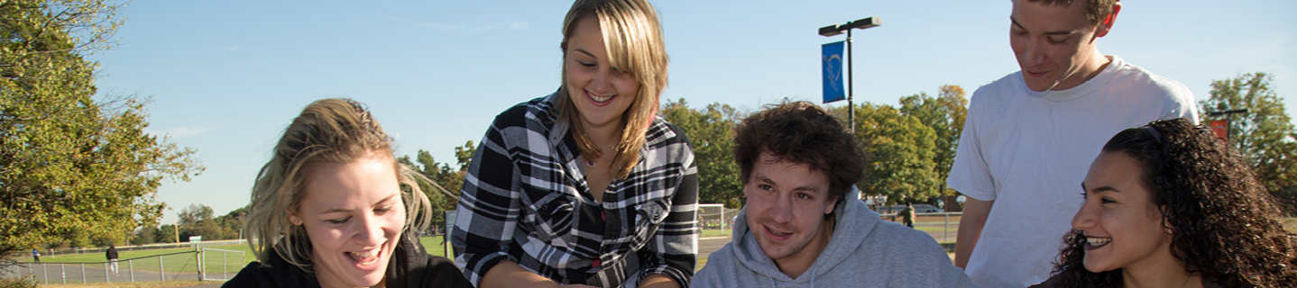 Students sitting outside at a table